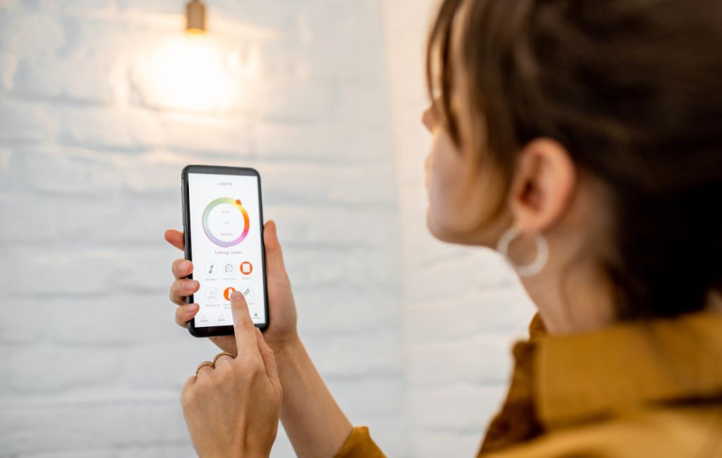 woman holding phone connected to the smart lighting